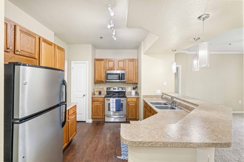 a kitchen with stainless steel appliances and wooden cabinets