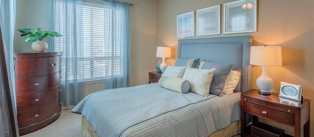 a bedroom with a bed and a dresser