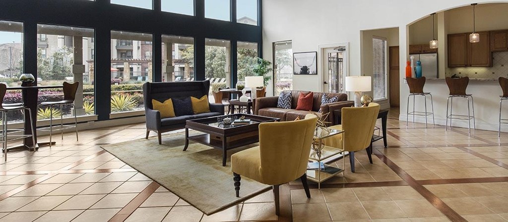 a living room with a couch and chairs and a table