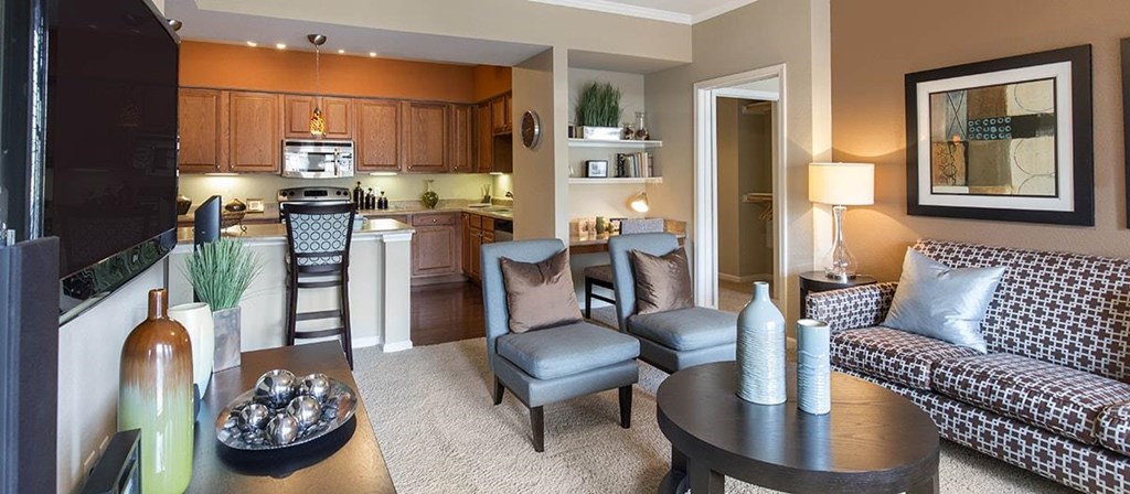 a living room and kitchen with a table and chairs
