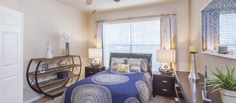 a bedroom with a bed and a large window