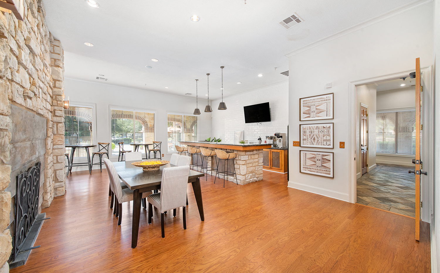 a dining room with a table and chairs in front of a fireplace