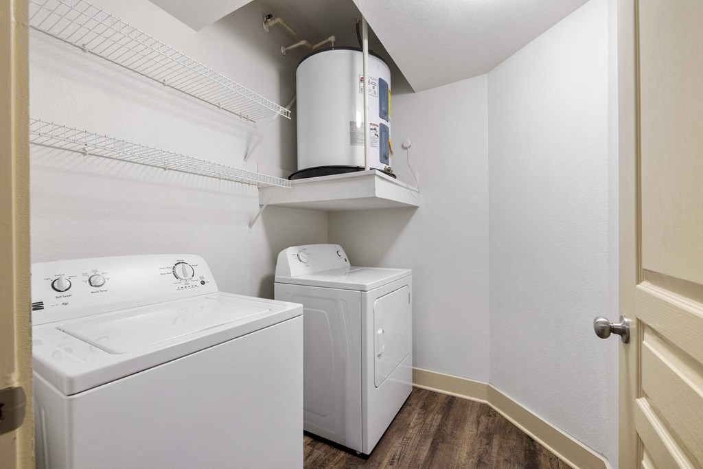 A white washing machine and dryer in a small laundry room.