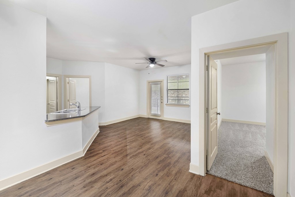 A room with wooden floors and a ceiling fan.