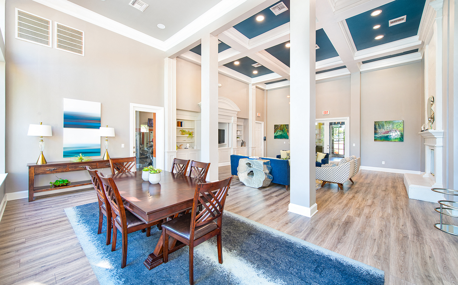 a dining room and living room with a wooden table and chairs