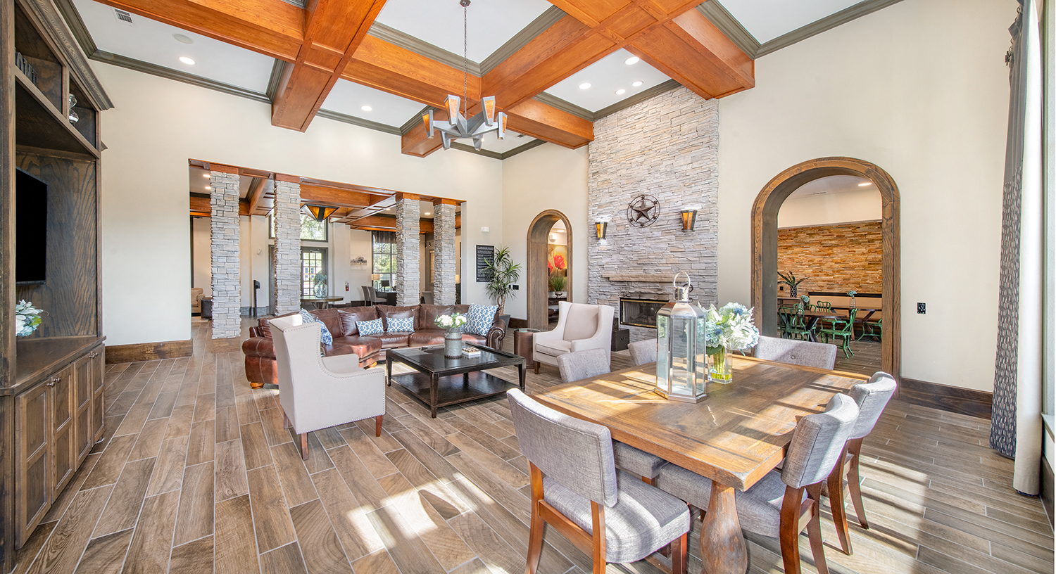 a living room with a large table and chairs