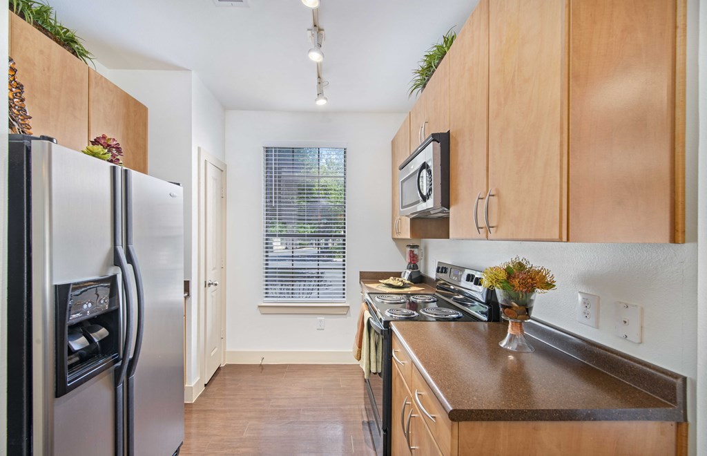 a kitchen with stainless steel appliances and wooden cabinets