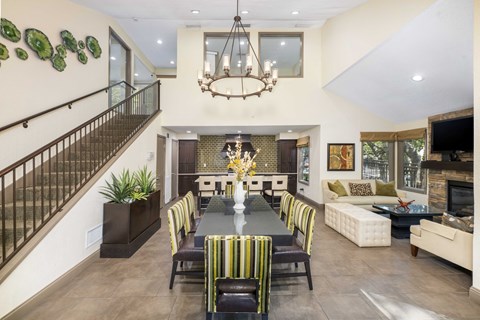 A dining room with a long table and chairs.