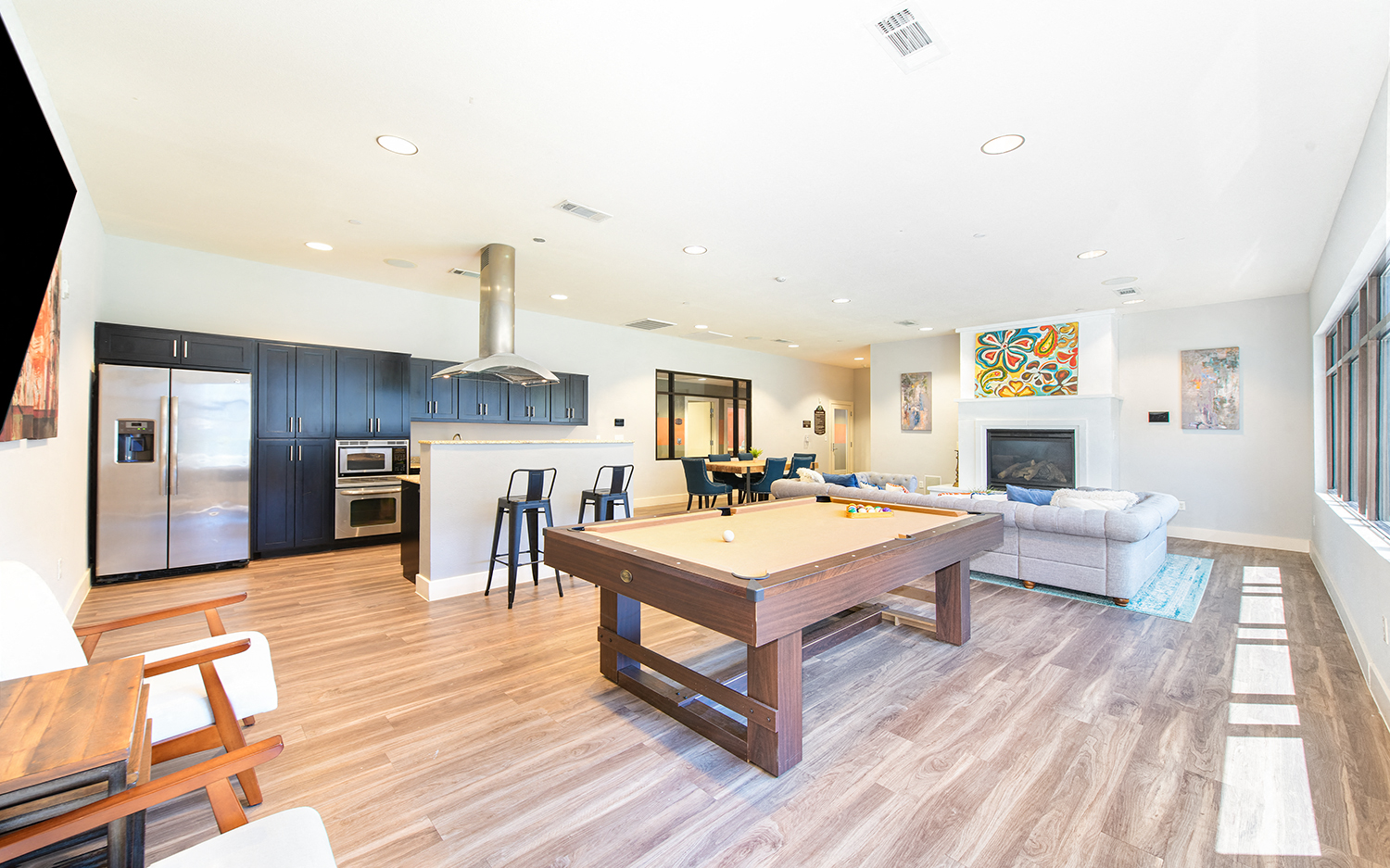a large living room with a pool table in the middle