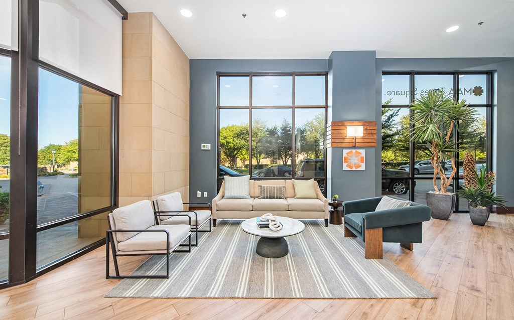 a living room with couches and chairs and a table