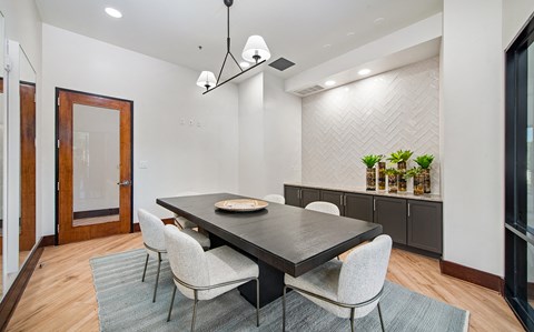 a dining room with a table and chairs and a large window