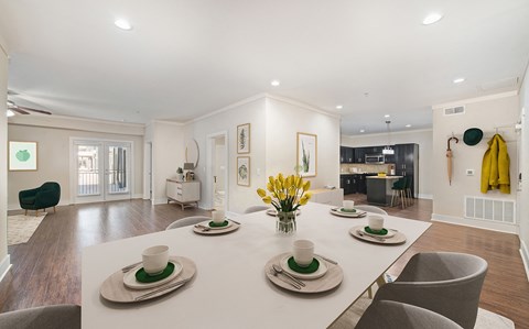 a dining room with a white table and chairs