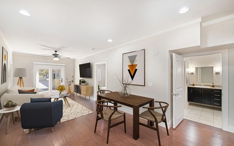 a living room and dining room with a table and chairs