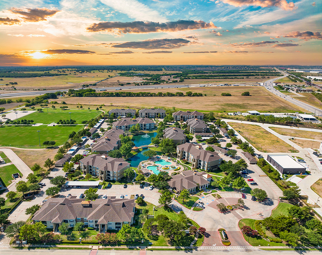 an aerial view of a neighborhood with houses and a swimming pool