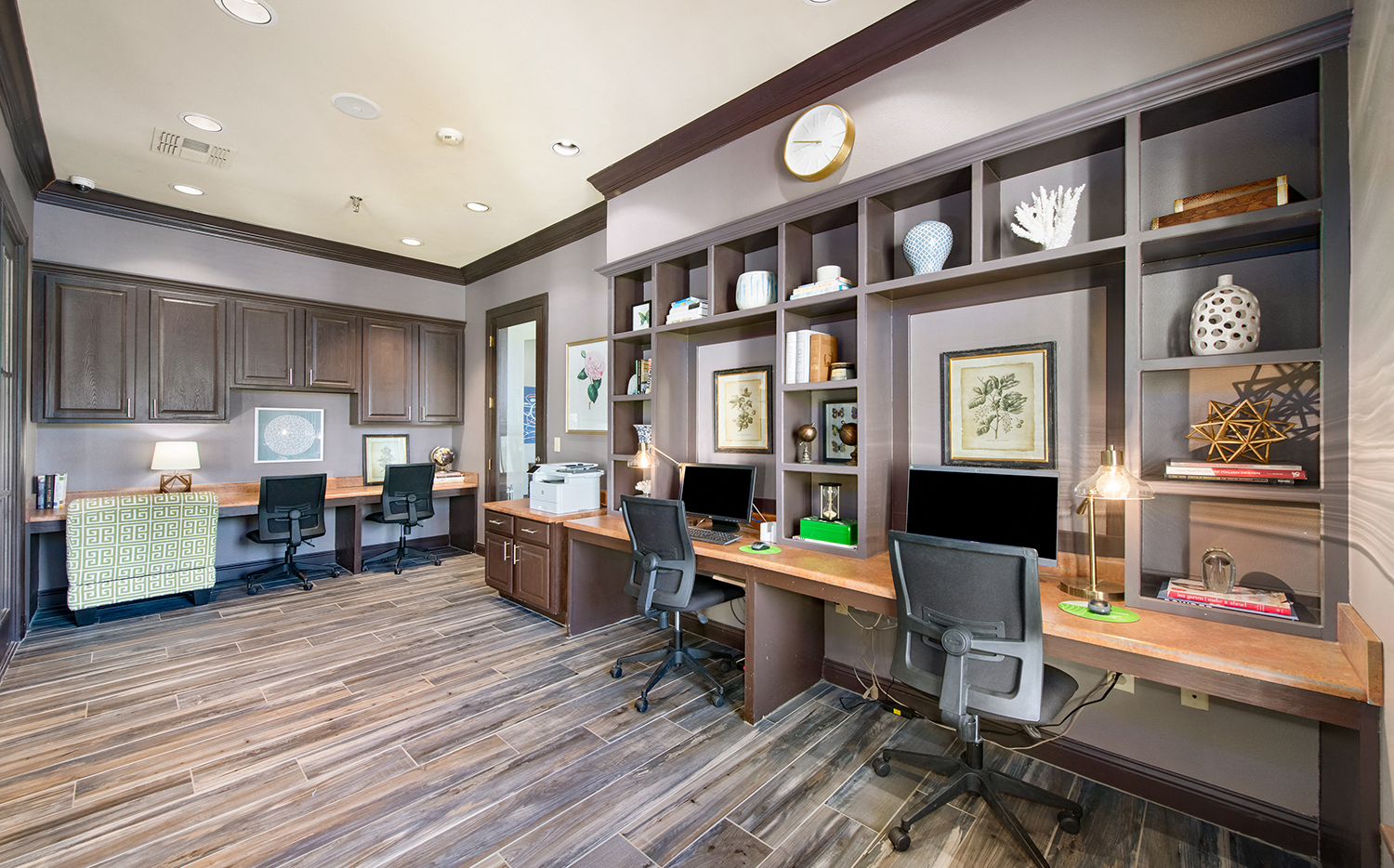a home office with two desks and two computer monitors