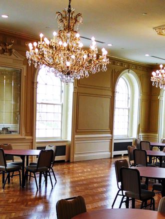 a dining room with tables and chairs and a chandelier