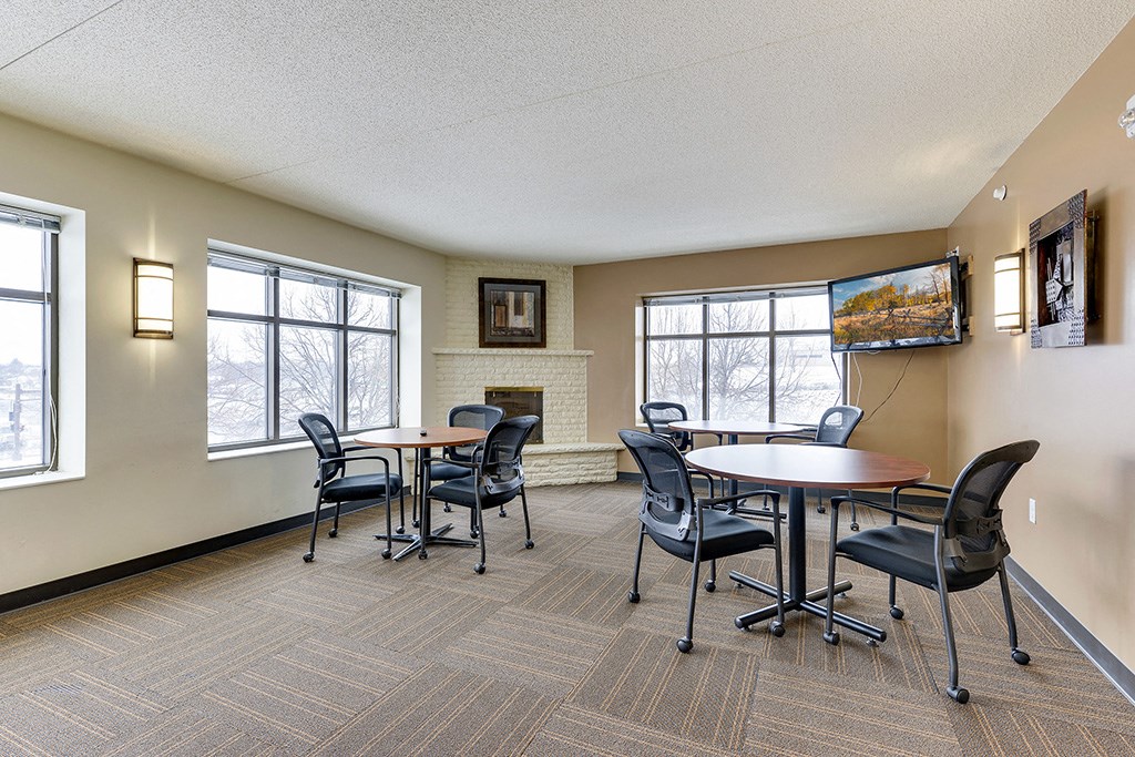 a conference room with tables and chairs and a fireplace