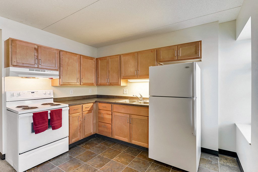 a kitchen with white appliances and wooden cabinets