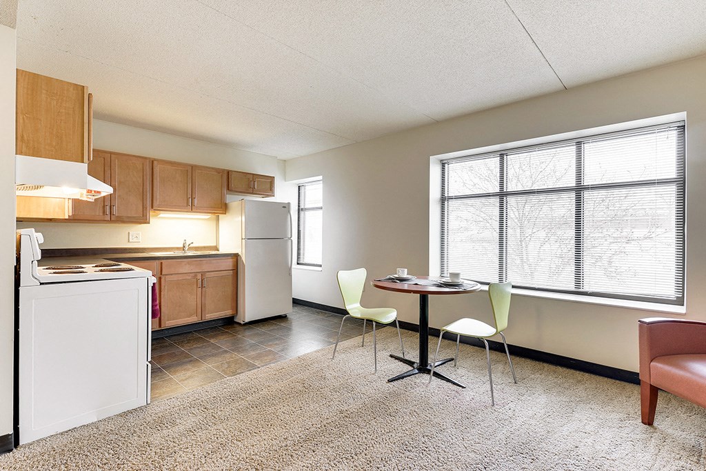 an empty kitchen and dining room with a table and chairs