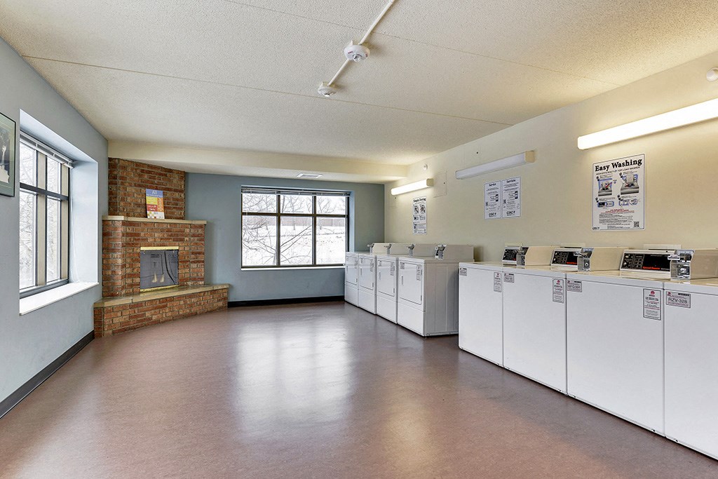 an empty room with washes and dryers in it