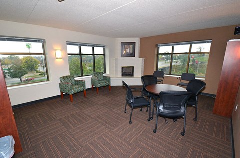 a conference room with a table and chairs and a fireplace