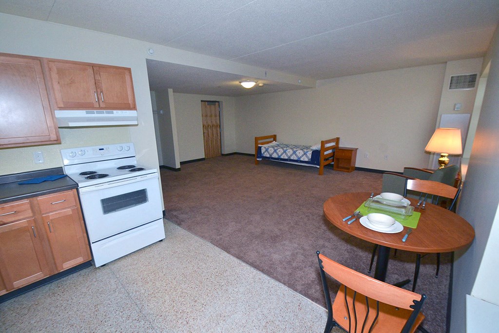a kitchen and living room with a table and a stove