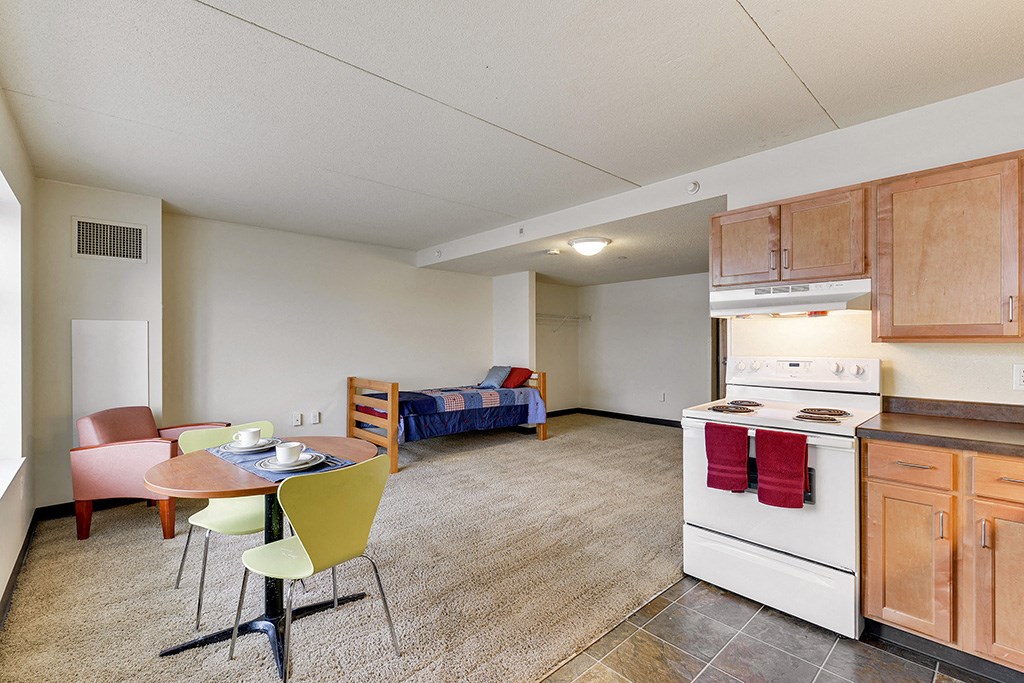 a kitchen and living room with a table and chairs