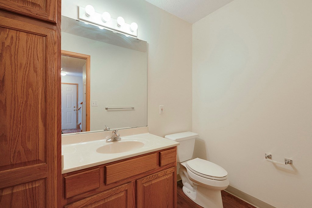 a bathroom with a sink toilet and a mirror