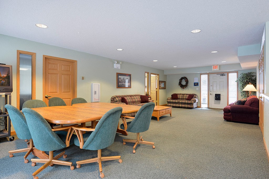 a conference room with a wooden table and chairs