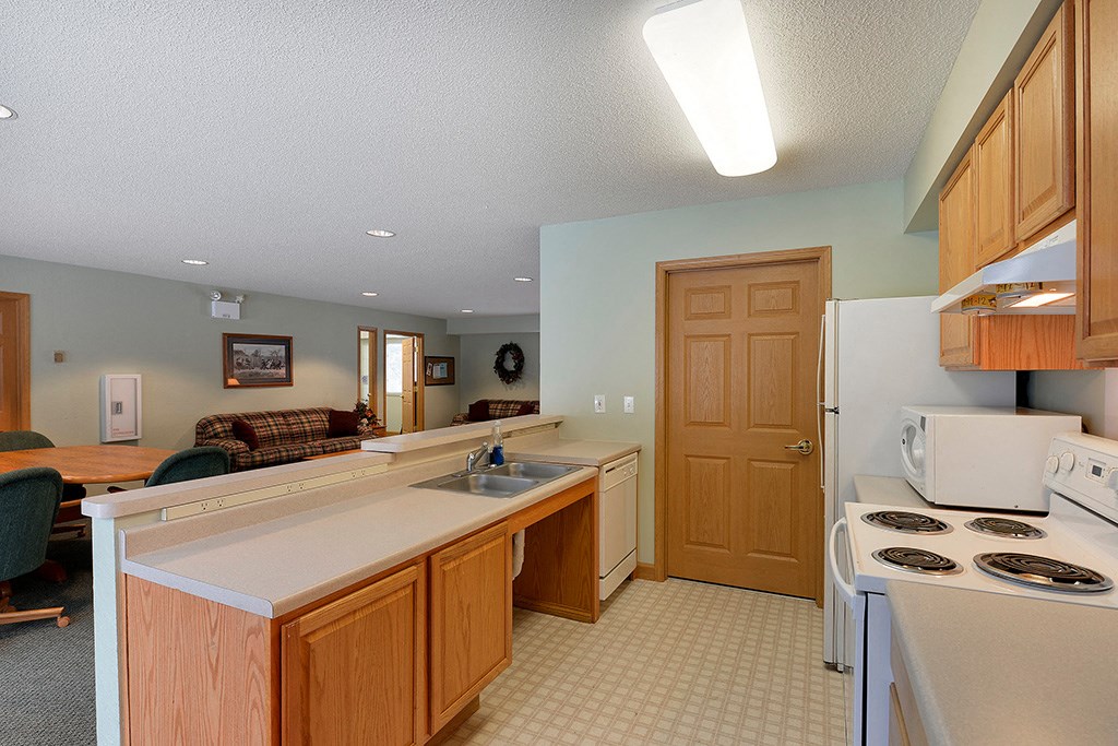 a kitchen with a stove top oven and a sink