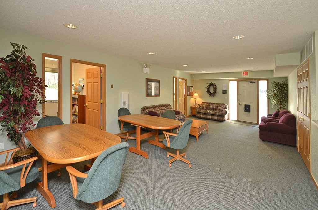 a living room with a wooden table and chairs