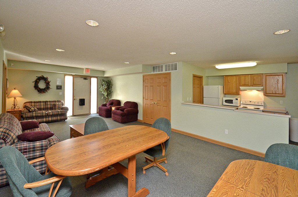a living room with a wooden table and furniture
