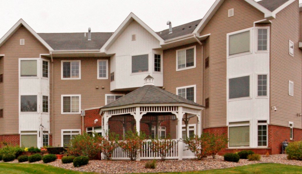 a gazebo in front of an apartment building