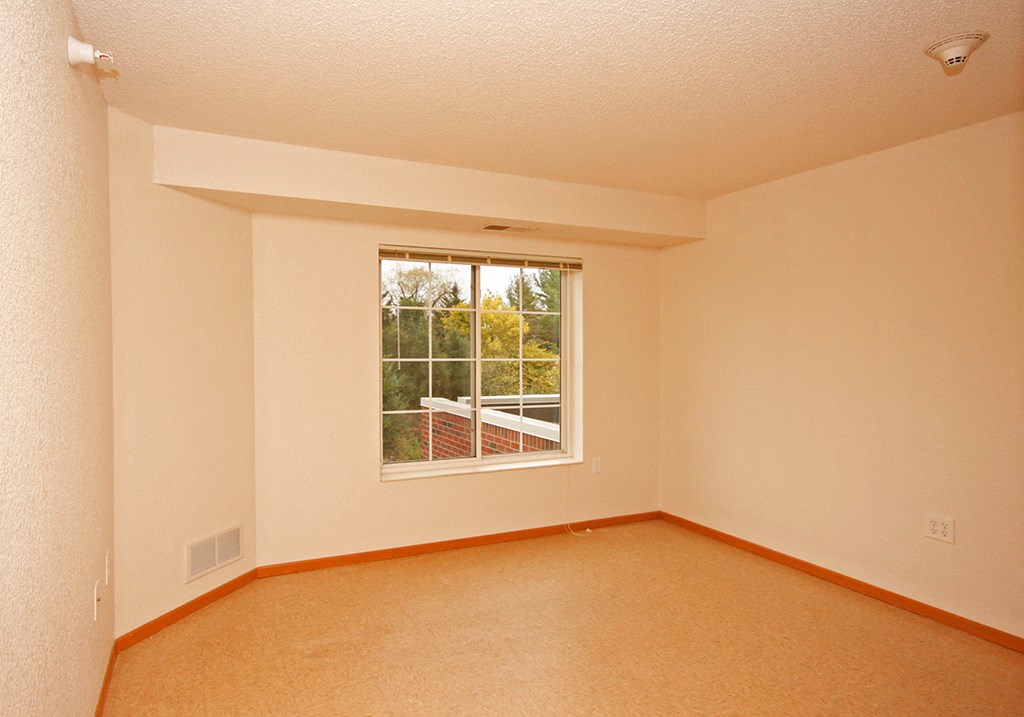 an empty living room with a large window