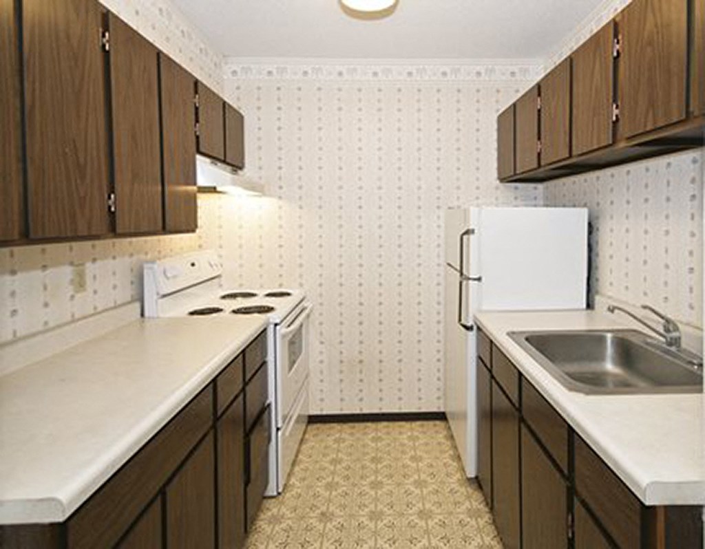 a kitchen with a sink a stove and a refrigerator