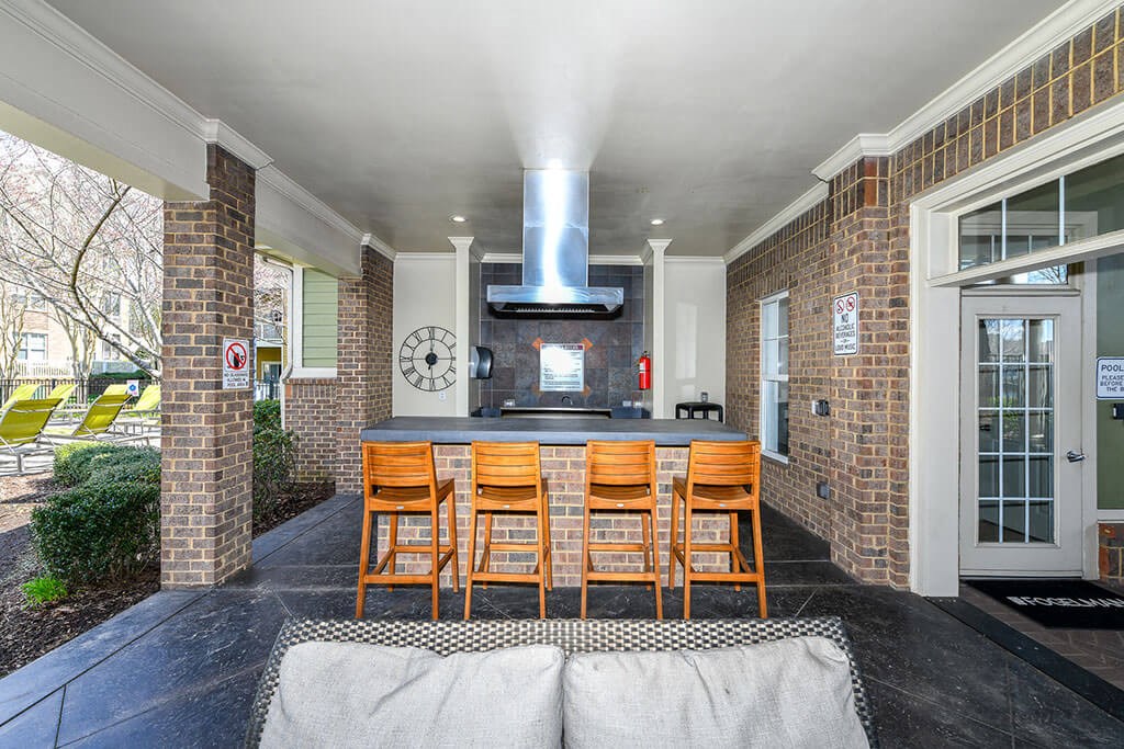 Outdoor Entertainment Space with Gas Grill and Bar Height Seating and Amble Counterspace at Alden Place at South Square Apartments, Durham, NC 27707