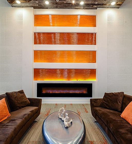 Stunning Modern Design Community Clubhouse with Gorgeous Tile Fireplace and Seating at EOS Apartments, Orlando, FL 32826