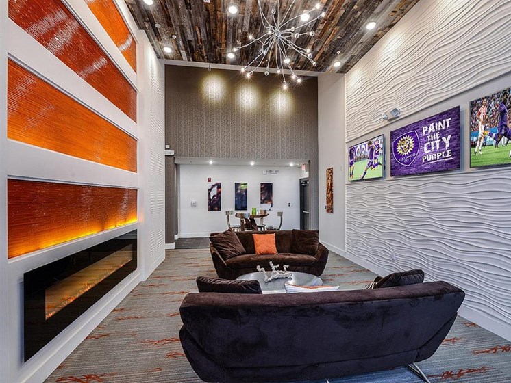 Stunning Modern Design Community Clubhouse with Gorgeous Tile Fireplace and Seating at EOS Apartments, Orlando, FL 32826