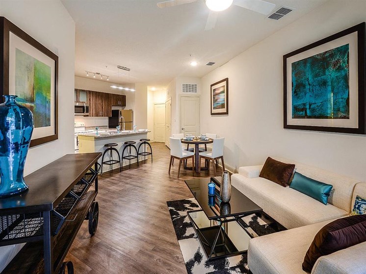 Open Floor Plan Kitchen with Wood Plank Vinyl Flooring (in Select Units) and Chef's Table-inspired Islands at EOS Apartments, Orlando, FL 32826