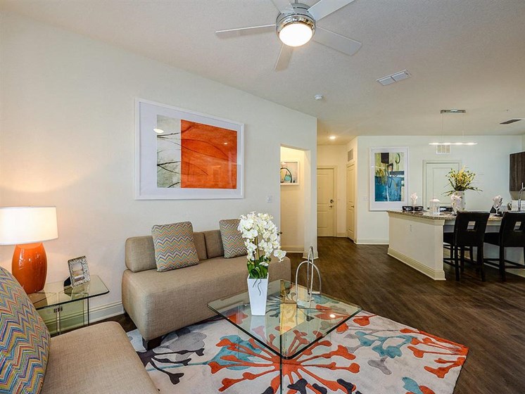 Open Floor Plan Living Rooms with Wood Plank Vinyl Flooring (in Select Units) and Vaulted Ceilings at EOS Apartments, Orlando, FL 32826