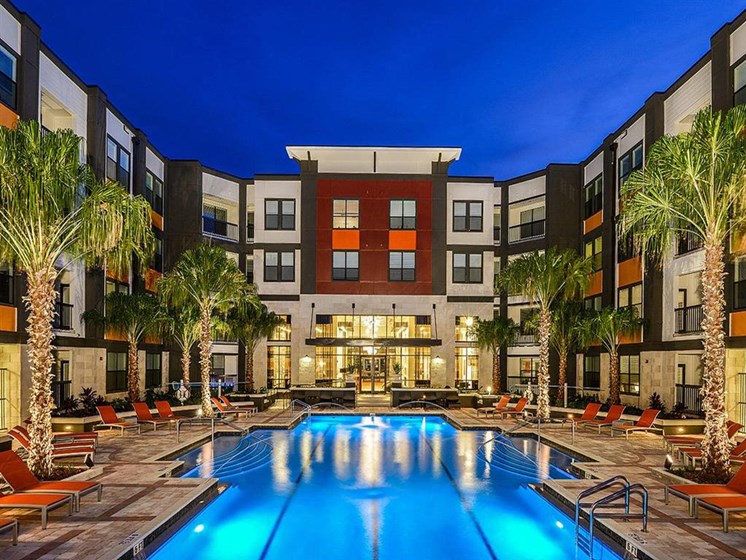 Revitalizing Resort Style Swimming Pool with Relaxation Space and Seating Area at EOS Apartments, Orlando, FL 32826
