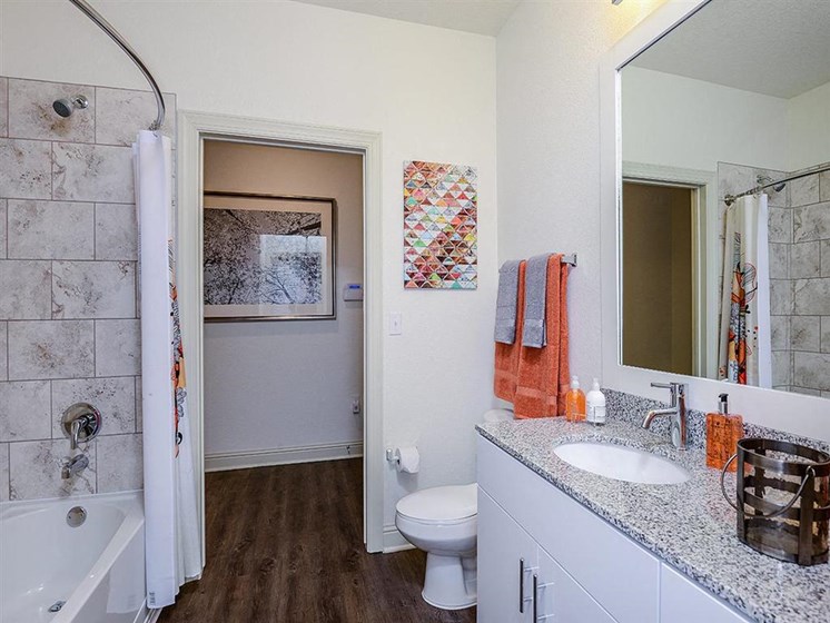 Relax after a long day in your bathroom with garden tub, granite countertops and walk-in showers at EOS Apartments, Orlando, FL 32826