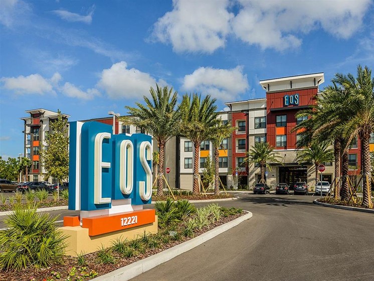 Lush landscaping surrounds you as you drive into EOS Apartments, Orlando, FL 32826