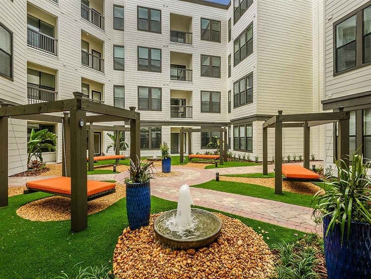 Relax in a peaceful Hammock Haven with the sound of trickling water to soothe your mind and soul at EOS Apartments, Orlando, FL 32826