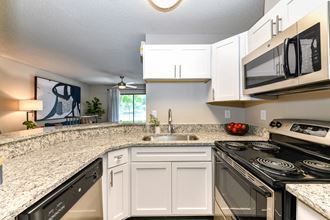 Kitchen with granite countertops and stainless steel appliances at 15Seventy, Chesterfield, MO 63017 - Photo Gallery 2