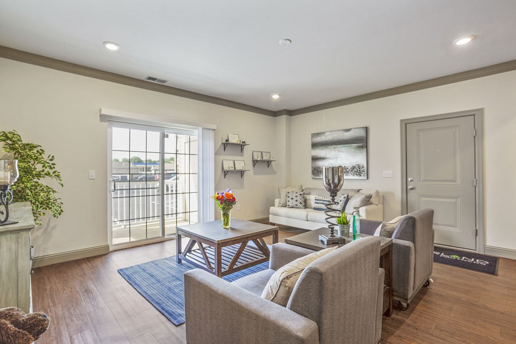 a living room with couches and chairs and a table