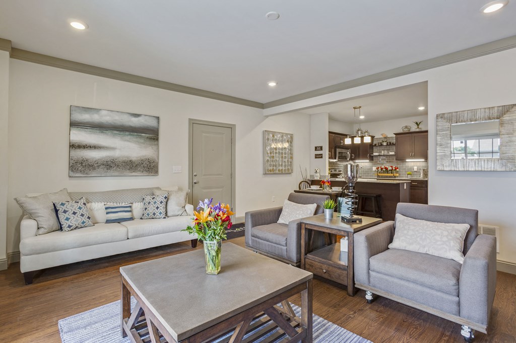 a living room with couches and chairs and a table