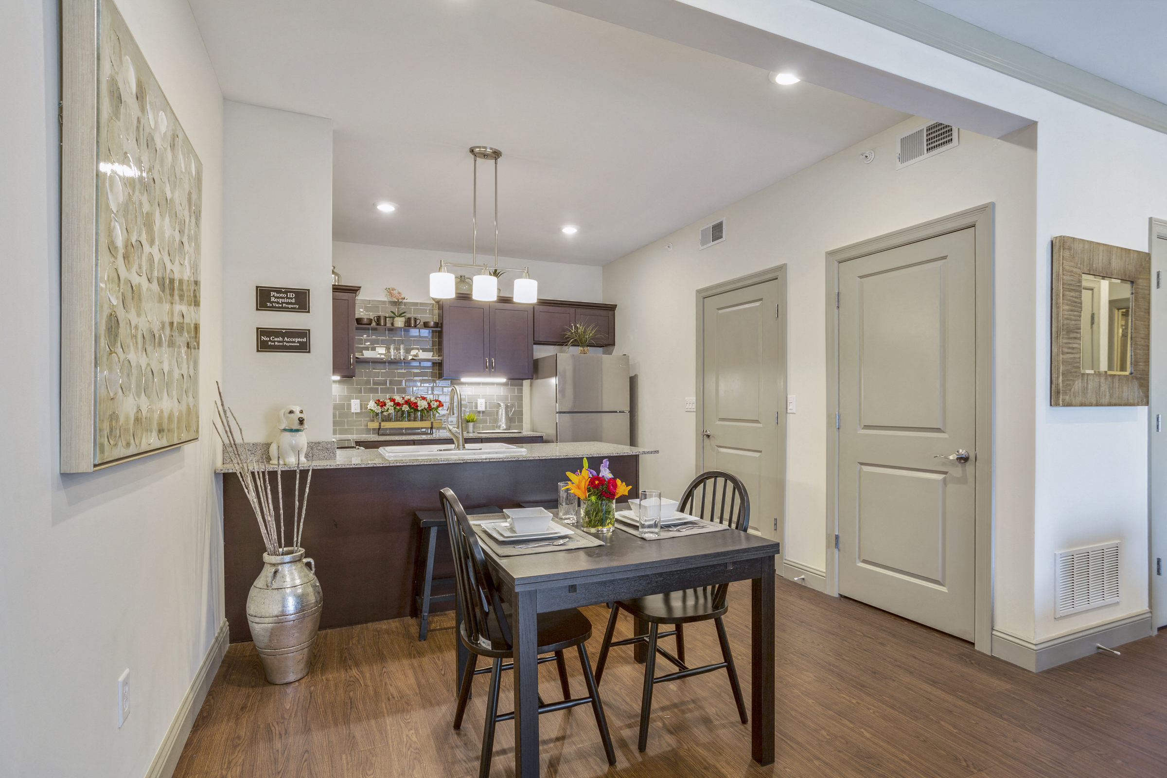 a dining room and kitchen with a table and chairs