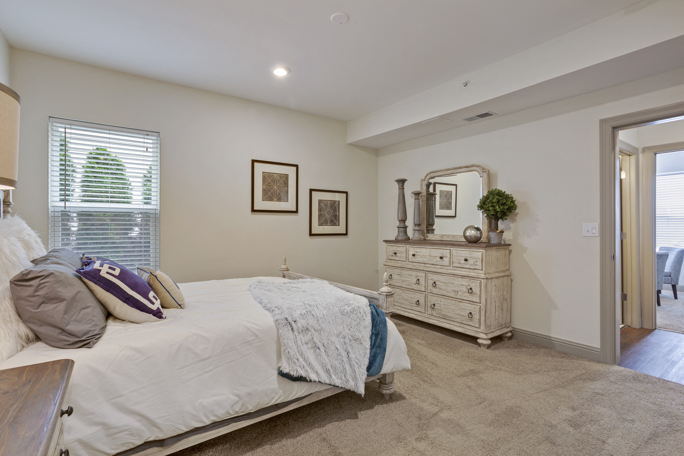 a bedroom with a bed and a dresser