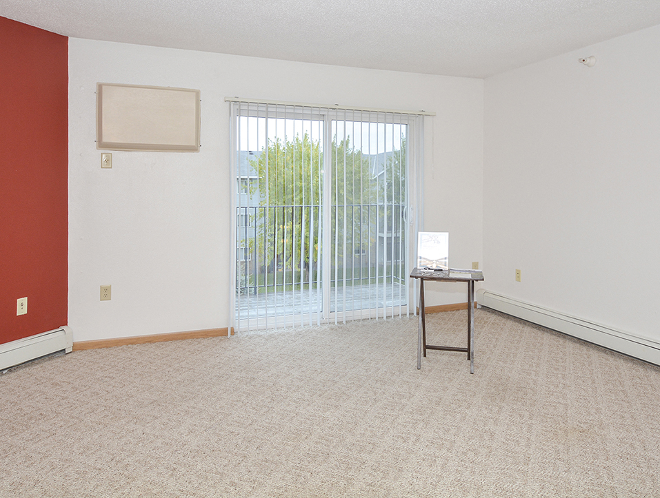 a living room with a sliding glass door and a table